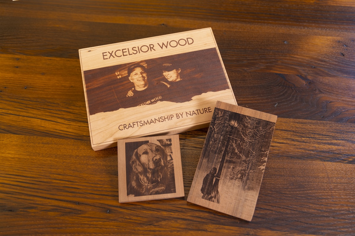 Photo of Excelsior Owner Ron Sauer and daughter engraved on a wood slab.